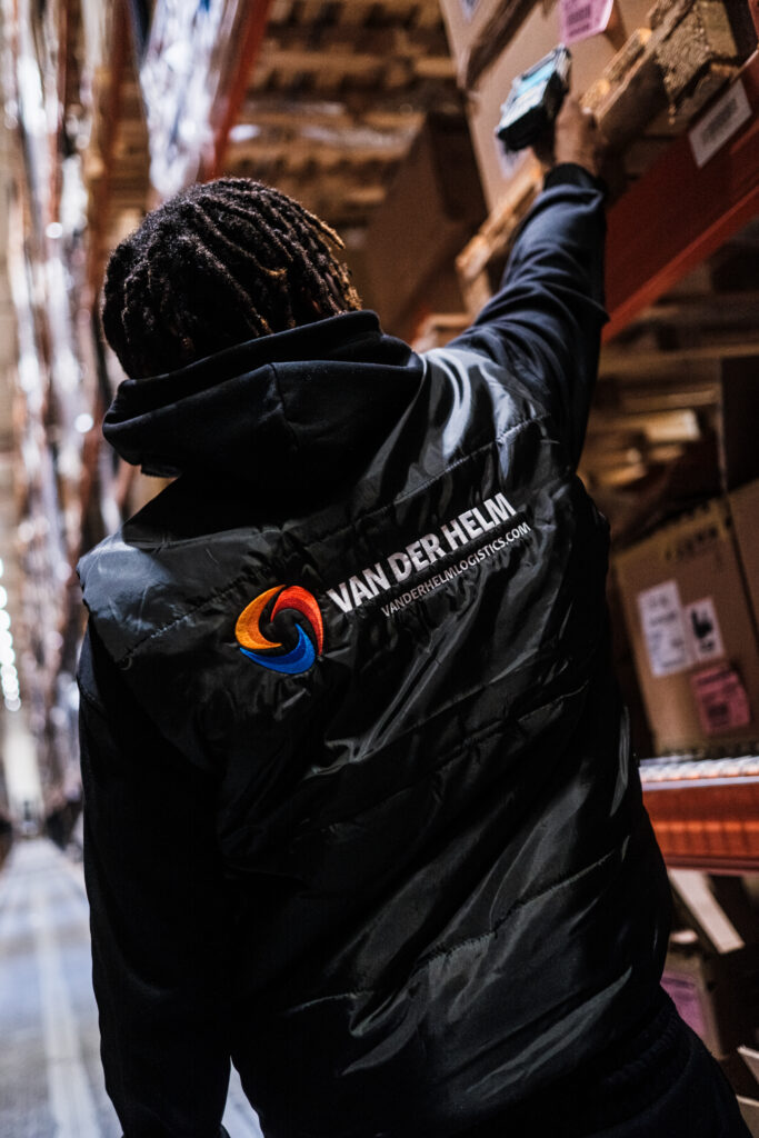 Person organizing boxes in warehouse.